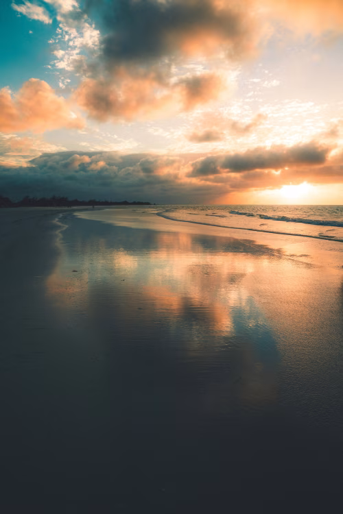 Scenic Ocean Sunset With Vibrant Reflection and Dynamic Cloudscape