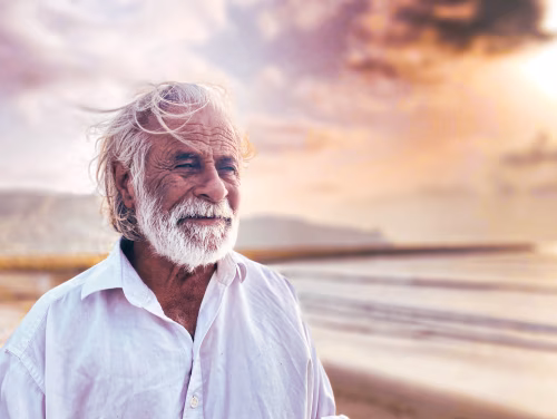 Senior Man With White Beard On Beach At Sunset, Calm, Thoughtful Portrait On Sand