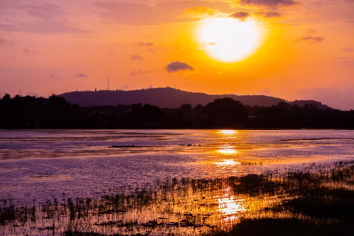 Serene Landscape With Vibrant Sunset Reflections Over Calm Waters