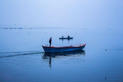 Serene Morning on a Calm Lake With Fishing Boats and Gentle Reflections