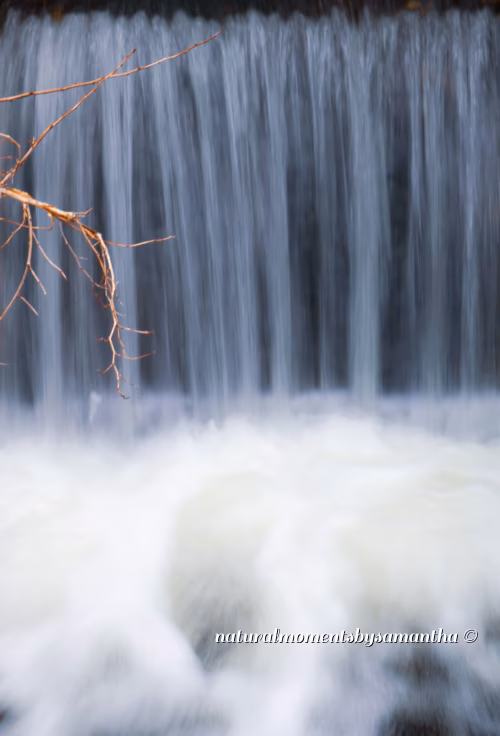 Serene Waterfall Flowing Through Rocky Terrain with Cascading Streams