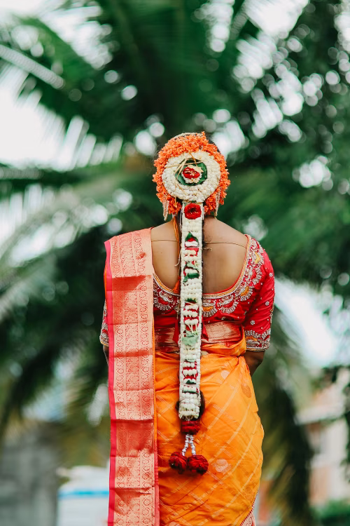 Traditional Indian Bridal Attire Highlighting Decorative Hair Ornamentation