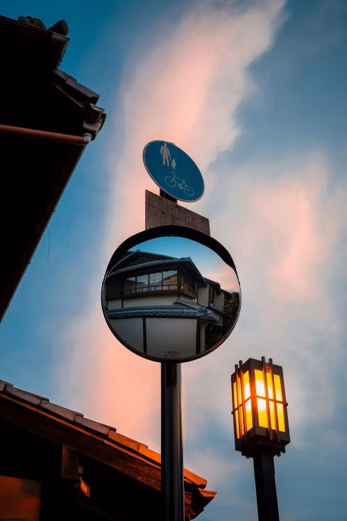 Urban Reflection in Traffic Mirror at Dusk with Traditional Architecture