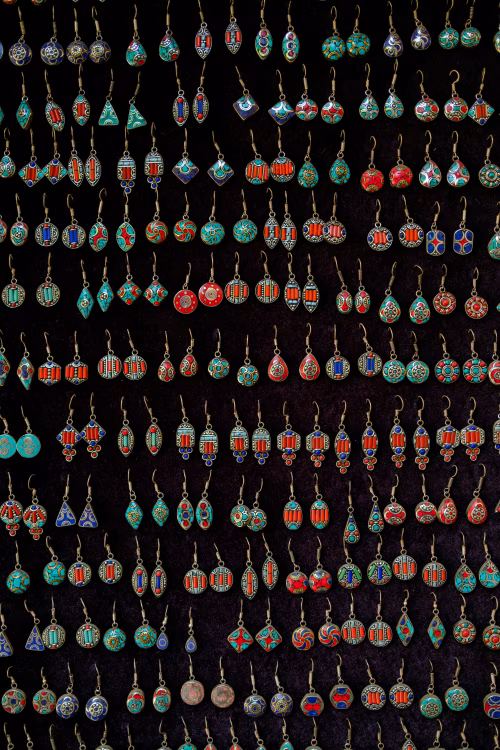 Vibrant Multicolored Artistic Earrings Displayed in Rows on Black Background